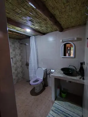 a bathroom with a toilet and a sink at DAR JOUD in Tabourahte