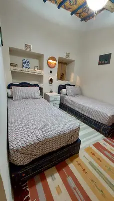 a bedroom with two beds in a room at DAR JOUD in Tabourahte