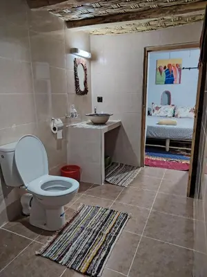 a bathroom with a toilet and a sink at DAR JOUD in Tabourahte