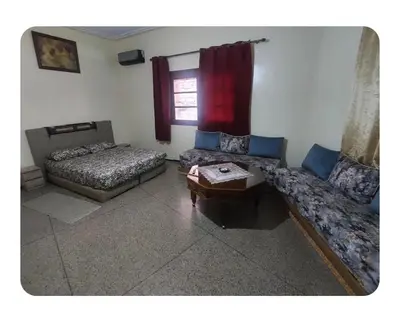 a living room with two beds and a couch at Studio Hamria Meknes in Meknès