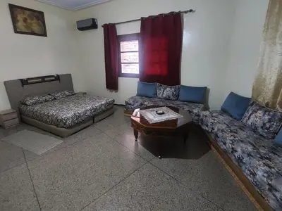 a living room with two beds and a coffee table at Studio Hamria Meknes in Meknès
