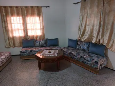 a living room with two couches and a coffee table at Studio Hamria Meknes in Meknès