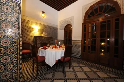 a dining room with a table with candles on it at Riad Au 20 Jasmins in Fès