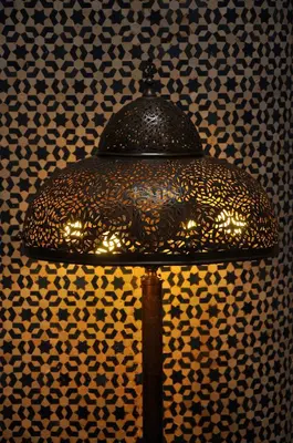 a lamp in a room with a patterned wall at Riad Au 20 Jasmins in Fès