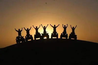 a group of people standing on top of a hill at Guest House familly takojt in Merzouga