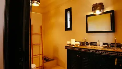 a bathroom with a sink and a mirror at Kasbah Caracalla in Aghmat