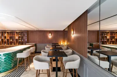 a restaurant with a pool and tables and chairs at Kenzi Rissani in Er Rachidia