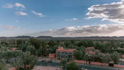 a view of a town with trees and a building at Kenzi Azghor in Ouarzazate