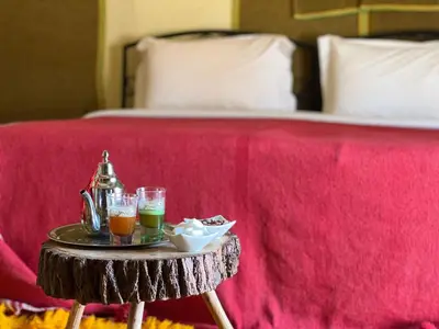 a tray of drinks on a table next to a bed at Your journey starts here in Merzouga