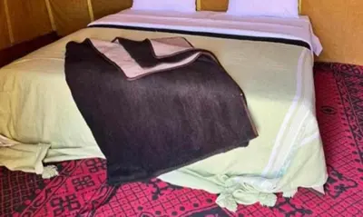 a black bag sitting on the end of a bed at Your journey starts here in Merzouga