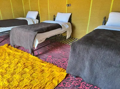 a group of three beds in a room at Your journey starts here in Merzouga