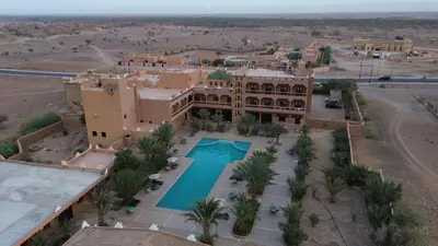 an aerial view of a building with a swimming pool at La Perle Du Drâa in Zagora