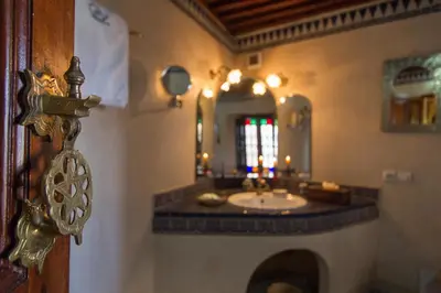 a bathroom with a sink and a mirror at Riad Norma in Fès