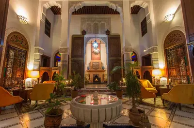 a large room with a fountain in the middle of a building at Riad Norma in Fès
