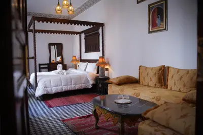 a living room with a bed and a couch at Riad Dar Chrifa - Luxury Escape in Fès