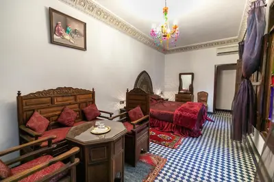 a bedroom with two beds and a bed and a couch at Riad Dar Chrifa - Luxury Escape in Fès
