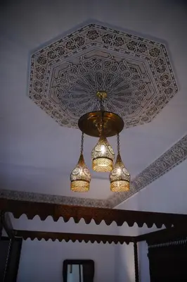 a chandelier hanging from a ceiling in a room at Riad Dar Chrifa - Luxury Escape in Fès