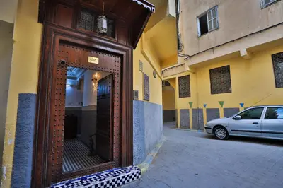 a wooden door on the side of a building at Riad Dar Chrifa - Luxury Escape in Fès