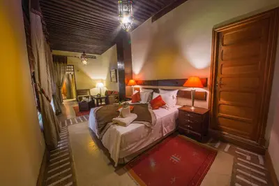 a bedroom with a large bed in a room at Dar victoria in Fès
