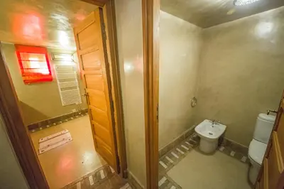 a small bathroom with a toilet and a sink at Dar victoria in Fès