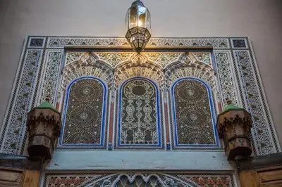 a chandelier is hanging above an ornate door at Dar victoria in Fès