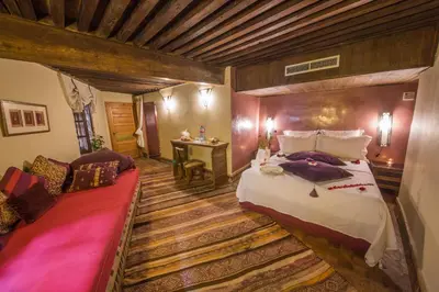 a bedroom with a large bed and a couch at Dar victoria in Fès