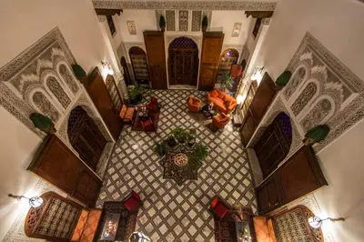 an overhead view of a living room with a tile floor at Riad - Dar Al Andalous in Fès