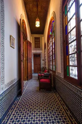 a hallway of a building with stained glass windows at Riad - Dar Al Andalous in Fès