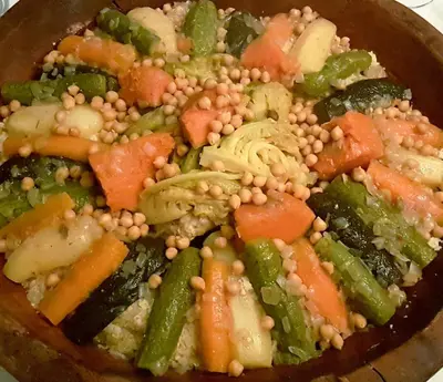 a bowl of food with peas and vegetables at Riad Souafine in Fès
