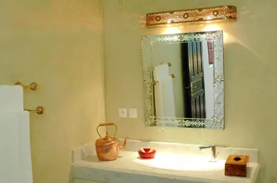 a bathroom with a sink and a mirror at Riad Souafine in Fès