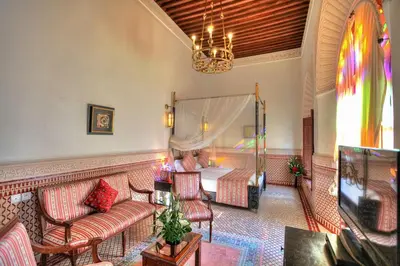 a living room with a bed and a couch at Riad El Amine Fès - Historic Hotels Worldwide in Fès