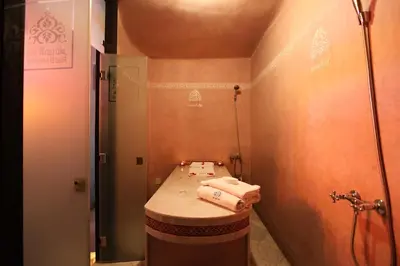 a small bathroom with a toilet with towels on it at Riad El Amine Fès - Historic Hotels Worldwide in Fès