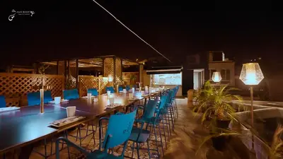 a long dining room with blue chairs and a long table at Riad El Amine Fès - Historic Hotels Worldwide in Fès