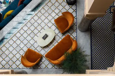 a table topped with orange seats on a table at Riad El Amine Fès - Historic Hotels Worldwide in Fès
