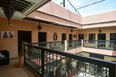 a balcony of a building with a swimming pool at Riad Yacout in Meknès