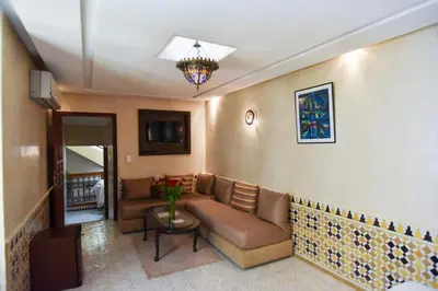 a living room with a couch and a table at Riad Yacout in Meknès
