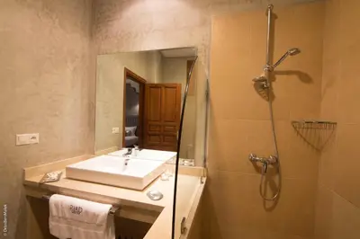 a bathroom with a sink and a shower at Riad Yacout in Meknès
