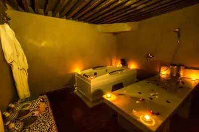 a room with a tub and a table with candles at Riad Fez Yamanda in Fès