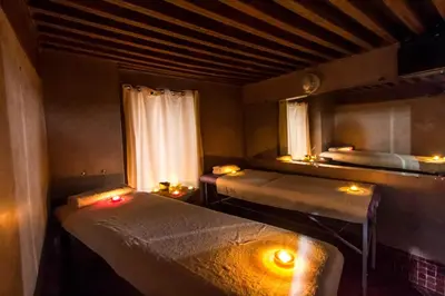 a room with two beds with candles and a window at Riad Fez Yamanda in Fès