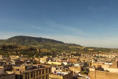a view of a city with a mountain in the background at Riad Fez Yamanda in Fès