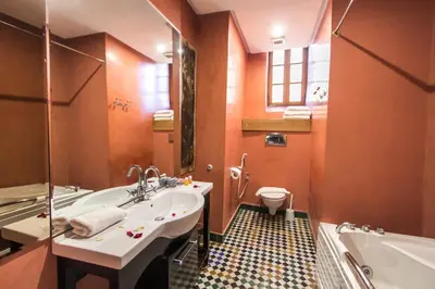 a bathroom with a sink and a tub and a toilet at Riad Fez Yamanda in Fès