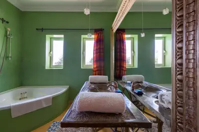 a bathroom with a tub and a sink and a bath tub at Sultana Royal Golf in Afeggou