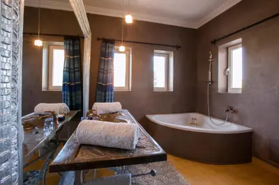 a large bathroom with a tub and a sink at Sultana Royal Golf in Afeggou