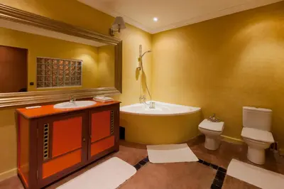 a bathroom with two sinks and a tub and a toilet at Sultana Royal Golf in Afeggou