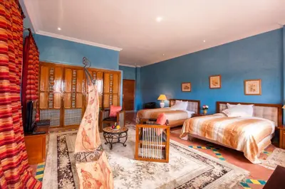 a bedroom with two beds and blue walls at Sultana Royal Golf in Afeggou