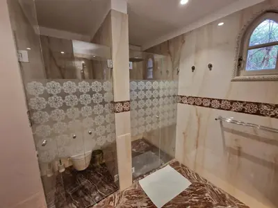 a bathroom with a shower and a toilet in it at Palace Africa - Marrakech Palmeraie in Marrakech