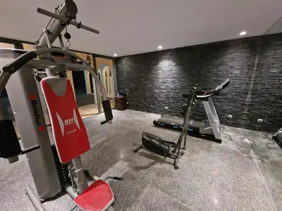 a gym with two exercise bikes in a room at Palace Africa - Marrakech Palmeraie in Marrakech