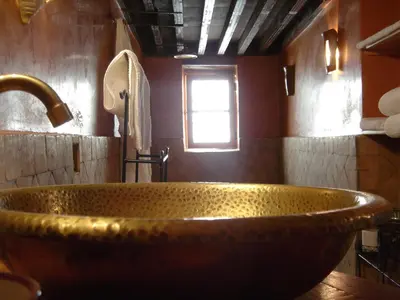 a bathroom with a large copper tub with a window at Riad La Clé De Fès in Fès