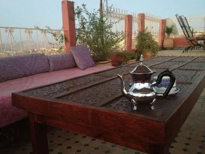 a tea kettle on a coffee table on a patio at Riad La Clé De Fès in Fès