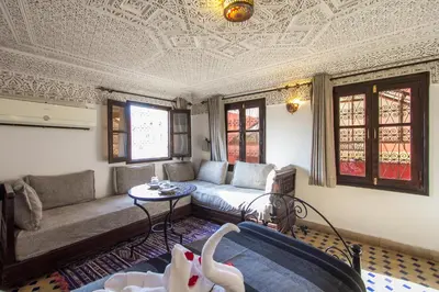 a living room with a couch and a table at Riad Hala in Fès